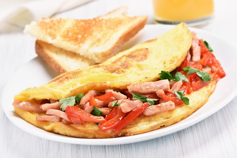 Omelette,With,Vegetables,And,Ham,On,White,Wooden,Table